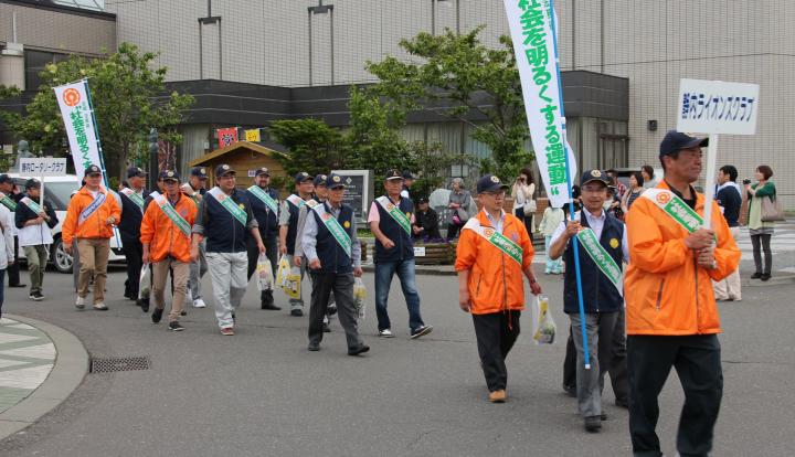 L.原 順一 会長、L.岡本 晃 社会奉仕委員長を先頭にパレードをする参加メンバー