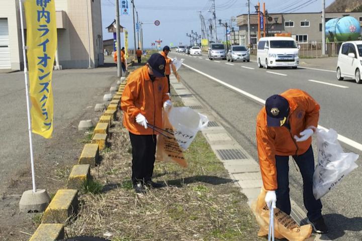 車検場付近でゴミを拾う会員たち。